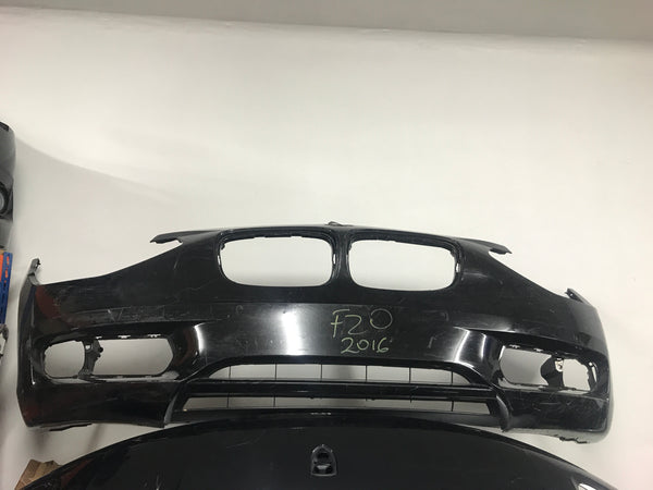 51117245731 BMW 1 series 2015 f20 front bumper in black no sensor holes, washer jets  needs respray.